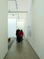 Exhibition hall in 798 Art Zone with contemporary artwork and visitors
