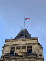 Luxembourg flag flying above the Grand Ducal Palace indicating the presence of the Grand Duke