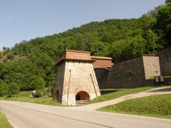 Old smelter in Adamov surrounded by trees and buildings