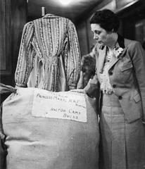 Mrs Waterson inspecting a bale of hospital comforts in the South African Volunteer Service packing room, London 1941