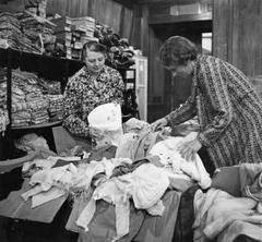 South African volunteer women sorting baby clothes at South African Volunteer Service in London 1941