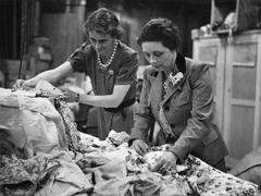 South African Volunteer Service members sorting children's dresses at South Africa House London in 1941