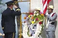 Chairman of the Joint Chiefs of Staff Gen. Martin E. Dempsey saluting after laying wreath at Manila American Cemetery and Memorial