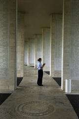 U.S. Coast Guard Lt. Sara Wallace walking through World War II cemetery and memorial in Manila during 74th Joint Civilian Orientation Conference