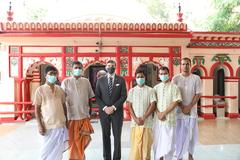 Ambassador Earl Miller visiting interfaith religious sites including a temple, mosque, and church