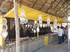 Sea Shell handicraft stall at Dhanushkodi Ghost Town with fisherman houses nearby