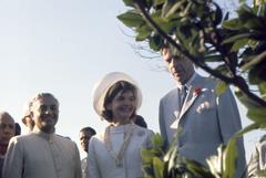 First Lady Jacqueline Kennedy visiting Raj Ghat, the memorial of Mohandas Gandhi in Delhi, India, flanked by Indian Chief of Protocol S. K. Banerji and US Ambassador John Kenneth Galbraith
