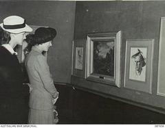 Mrs. G.M. Norris and Mrs. K. D. MacDougal viewing paintings at Athenaeum Gallery exhibition