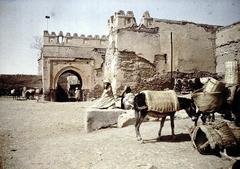 Bab Aghmat gate on the city walls of Marrakesh with people and donkeys