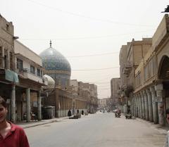 Al Rasheed Street in Baghdad bustling urban scene with cars and buildings
