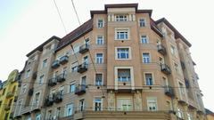 Street view of Népszínház utca with buildings and vehicles