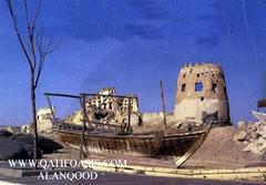 View of Darin Castle with a fishing boat in front