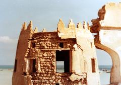 View of Darin Castle with its fortified walls and towers by the sea