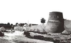 Ancient walls and towers of Qatif Castle with limestone piles in front