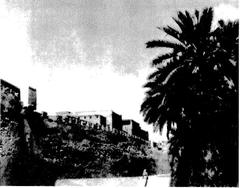Historical image of Al-Qatif wall with riflemen standing along the top, dated 1937
