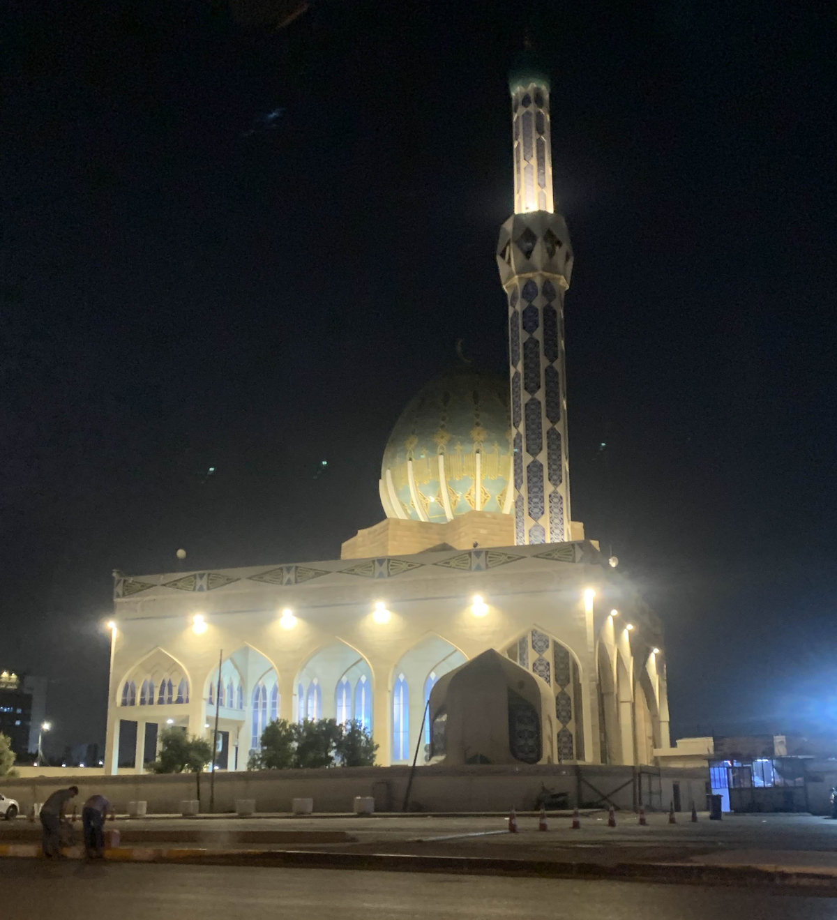 The Ibn Bunnieh Mosque in Baghdad illuminated at night viewed from inside a taxi