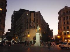 Talaat Harb Square with historic buildings and palm trees in Cairo, Egypt