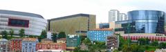 Architectural panoramic view of Basurtu-Zorrotza district in Bilbao from Frank Gehry Bridge with landmarks including San Mamés Stadium, EUITI building, Garellano Towers, and Bami building.