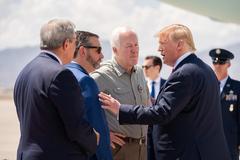 President Donald J. Trump and First Lady Melania Trump disembark Air Force One at El Paso International Airport on August 7, 2019, greeted by Texas Governor Greg Abbott, Senators John Cornyn and Ted Cruz, and El Paso Mayor Dee Margo