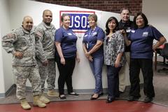 U.S. Army Sgt. Maj. Theodore Rivera and Maj. Rodney Lamberson with United Service Organizations representatives at El Paso International Airport for Army Trials 2015