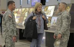 U.S. Army Reserve Maj. Janet Rose speaking with Staff Sgt. Christopher Rivera and Sgt. 1st Class Robert Pedero at El Paso International Airport