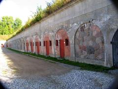 Garderhoj Fort Retiraderne outdoor public restrooms with historic stone wall in the background