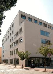 Free University of Bozen-Bolzano campus building with mountains in the background