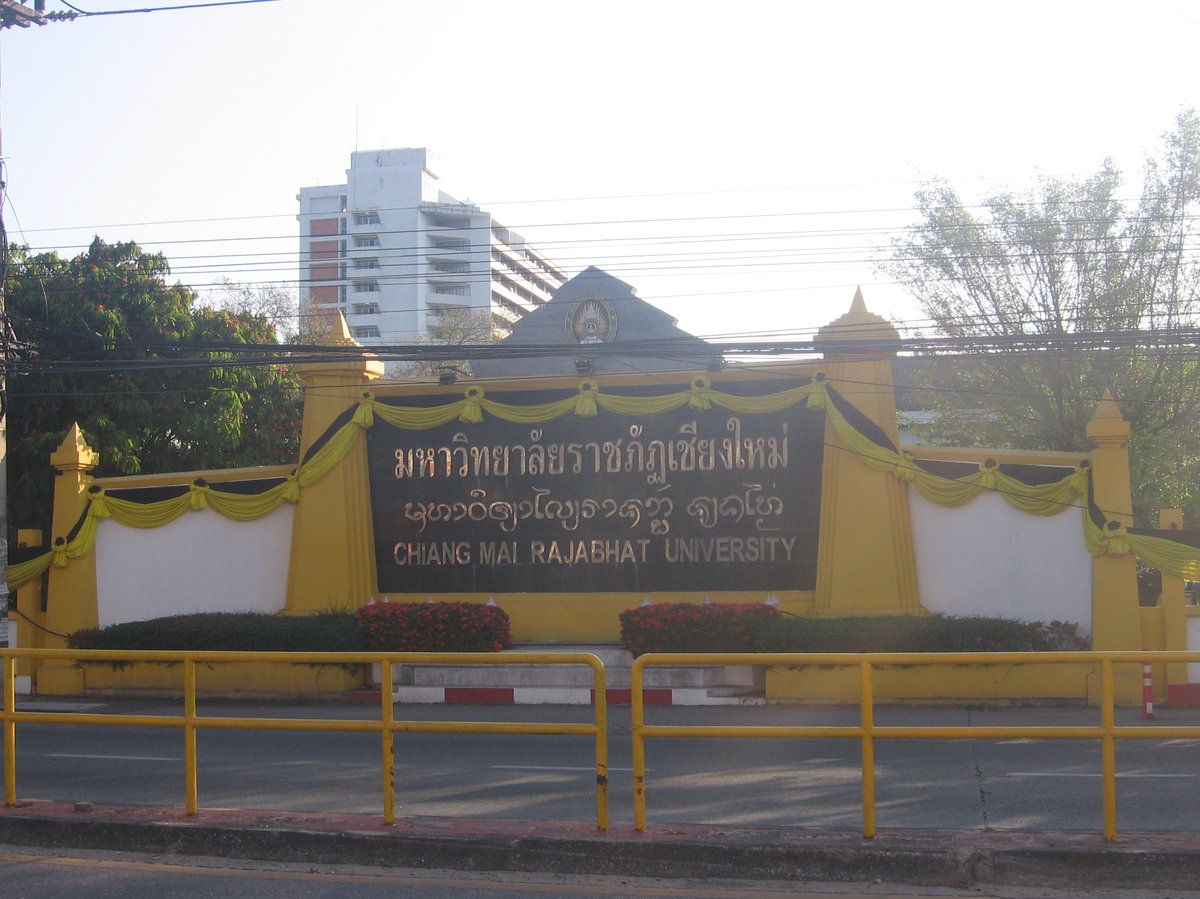 Chiang Mai Rajabhat University campus in Chiang Mai, Thailand with lush greenery and scenic hills in background