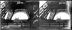 Group of people at the foot of the Eiffel Tower with Trocadero Palace in the background