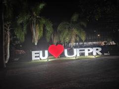 Illuminated building at night with graffiti Eu♥UFPR