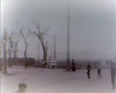 Historic black and white screenshot from 1907 film showing Trianglen square at Blegdamsvej and Øster Alle in Copenhagen with early 20th-century buildings and street scene
