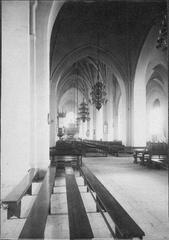 Interior view of Västerås Cathedral nave with wooden roof structure and stone arches