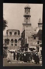 Group of people gathered in front of a large historic mosque in Cairo, Egypt