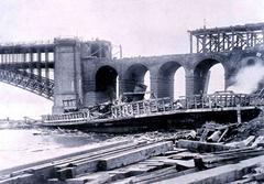 Eads Bridge damaged by the Great Cyclone of St. Louis with missing superstructure over the river