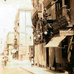 Kingsway Valletta street scene 1910s with Pohoomull Brothers Indian textile shop and little girl in traditional għonnella dress
