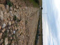 Historic Via Augusta road near Benlloch in Spain with surrounding hills and vegetation