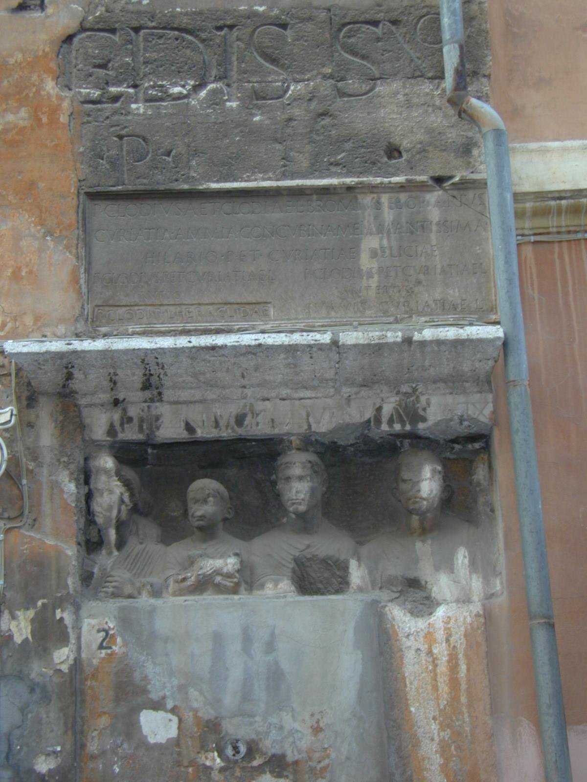 Roman stone inscriptions embedded in the wall of Casa Manili at the Portico di Ottavia in Rome