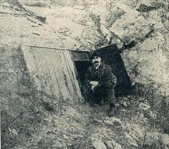 Entrance of Pál-völgy Cave surrounded by rocky terrain and greenery
