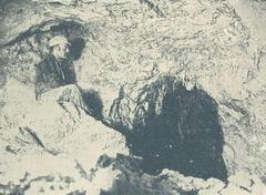 Entrance of Pál-völgy Cave with rocky cliffs and greenery
