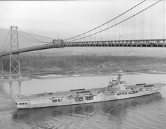 H.M.C.S. Warrior naval ship passing under the Lions' Gate Bridge in Vancouver