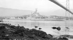 HMS Warrior warship passing under Lions Gate Bridge in Vancouver harbor