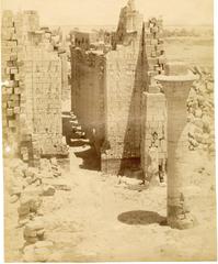 First courtyard of Karnak Temple Complex from the first pylon showing Taharqa kiosk column, Seti I Great Hypostyle Hall corridor, and obelisks of Thutmose I and Queen Hatshepsut