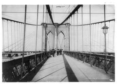 View of the Brooklyn Bridge with pedestrians walking on the walkway