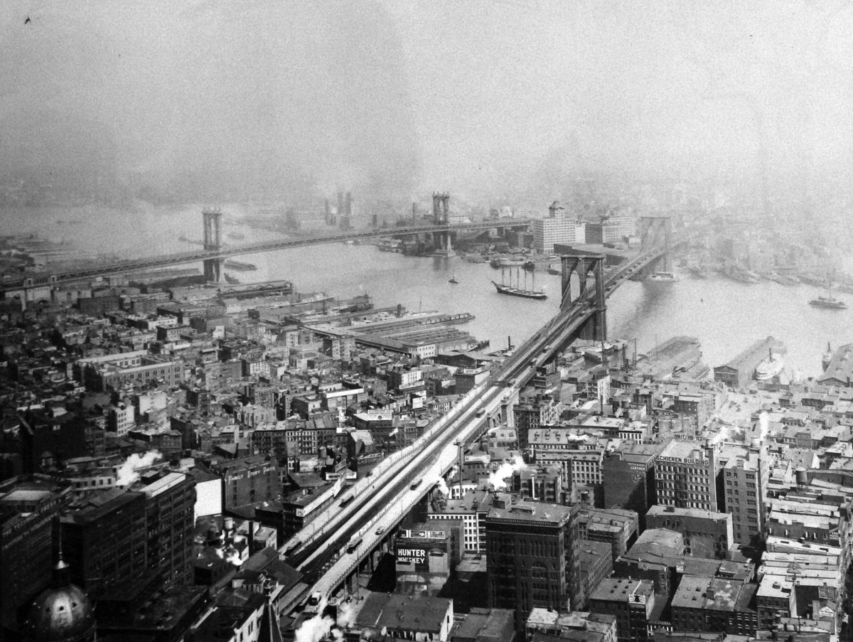 Historic view of Brooklyn Bridge and Manhattan Bridge with New York City skyline in 1916