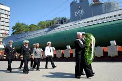 US Navy sailors carrying a ceremonial wreath during a wreath laying ceremony in Vladivostok, Russia