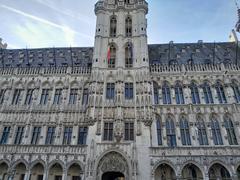 Brussels City Hall in Belgium with gothic architecture and a tall spire under a clear blue sky