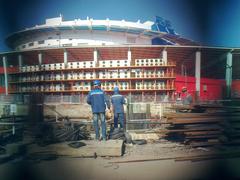 Construction site on Aviakonstruktora Sukhogo Street with building materials and machinery