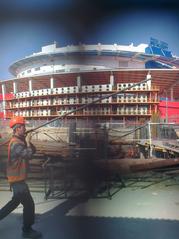 Construction work on Aviakonstruktora Sukhogo Street with machinery and building materials