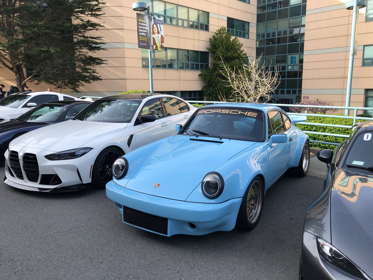 Car meetup at San Francisco State University showing a group of vintage cars and attendees