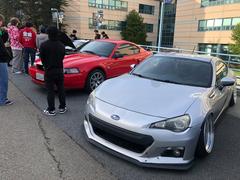 Car meetup at San Francisco State University with vintage cars and enthusiastic crowd on a sunny day